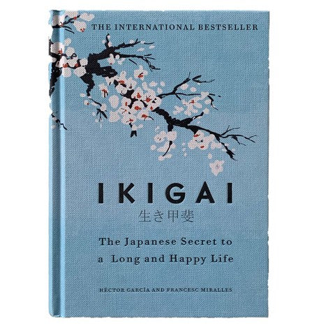 Book titled 'IKIGAI' with cherry blossom design on a light blue background